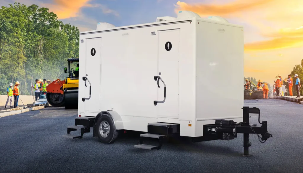 2-Stall Restroom Trailer sitting in the street of a construction site