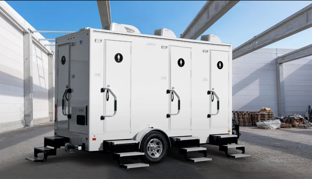 4 Stall Restroom Trailer (4 Doors) sitting at a construction job site