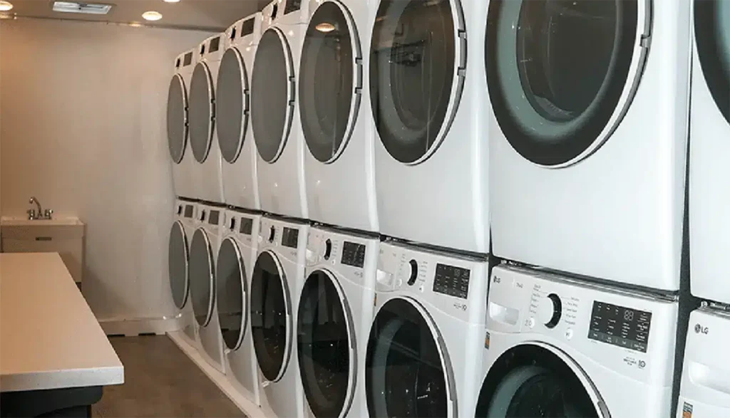 Inside of an 8-station laundry trailer rental unit