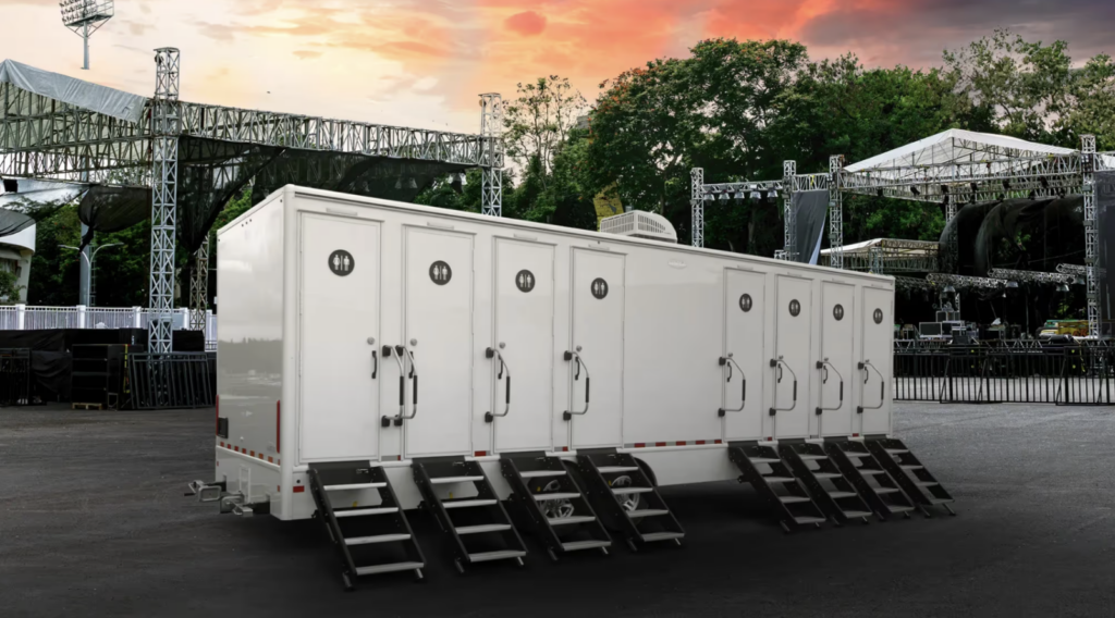 8 Stall Restroom Trailer sitting in the VIP area of a parking lot for a concert