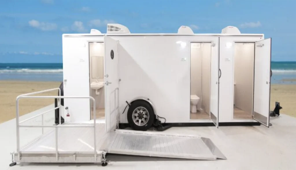 ADA Plus 2-Station Restroom Trailer on the beach